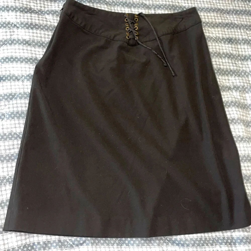 Women’s size 6, black pencil skirt stretchy. Lattice lace up. Hidden side zipper